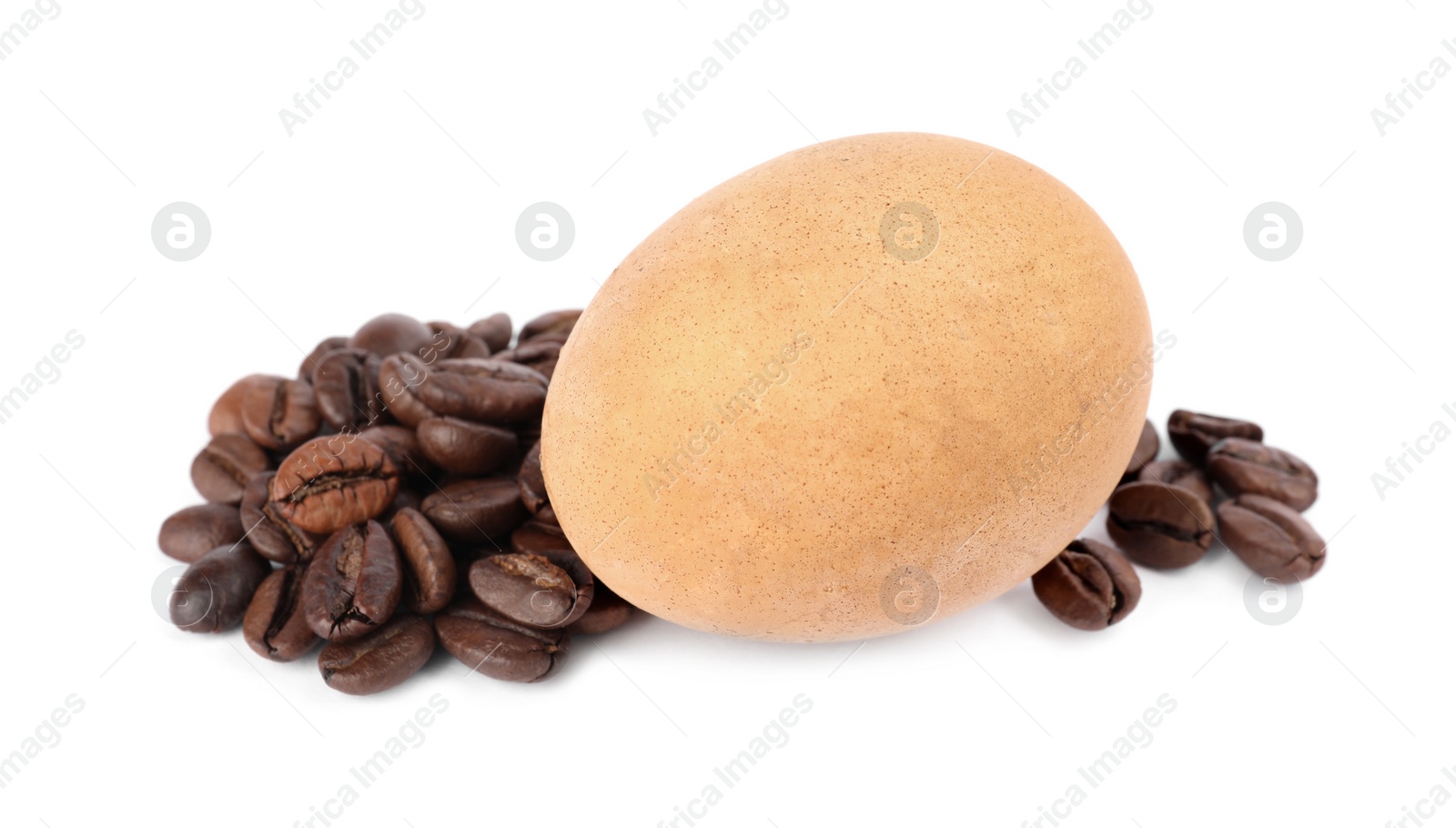 Photo of Easter egg painted with natural dye and coffee beans on white background