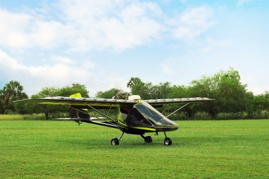Photo of Modern light aircraft on green grass outdoors