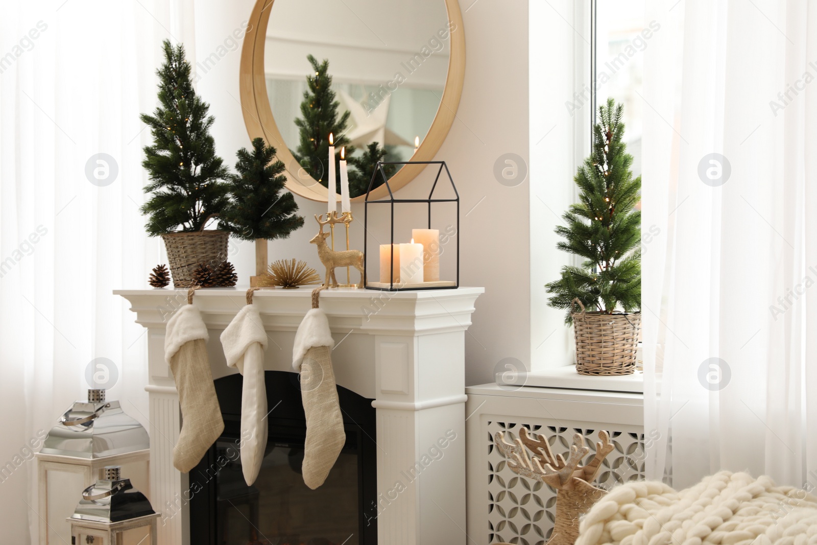 Photo of Fireplace in room with Christmas decorations. Interior design