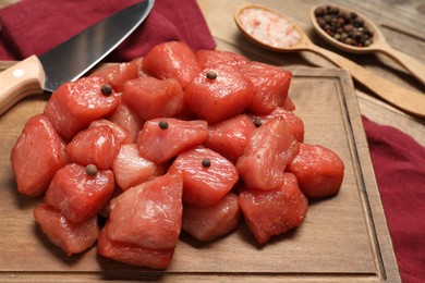 Photo of Cooking delicious goulash. Raw beef meat with spices on table, closeup