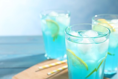 Photo of Delicious cocktail with ice on table, closeup. Space for text