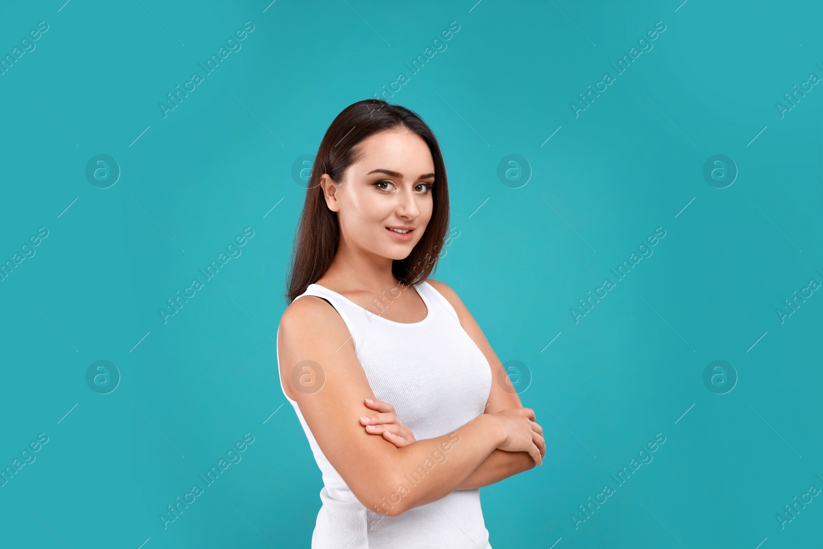 Photo of Beautiful young woman in casual outfit on turquoise background