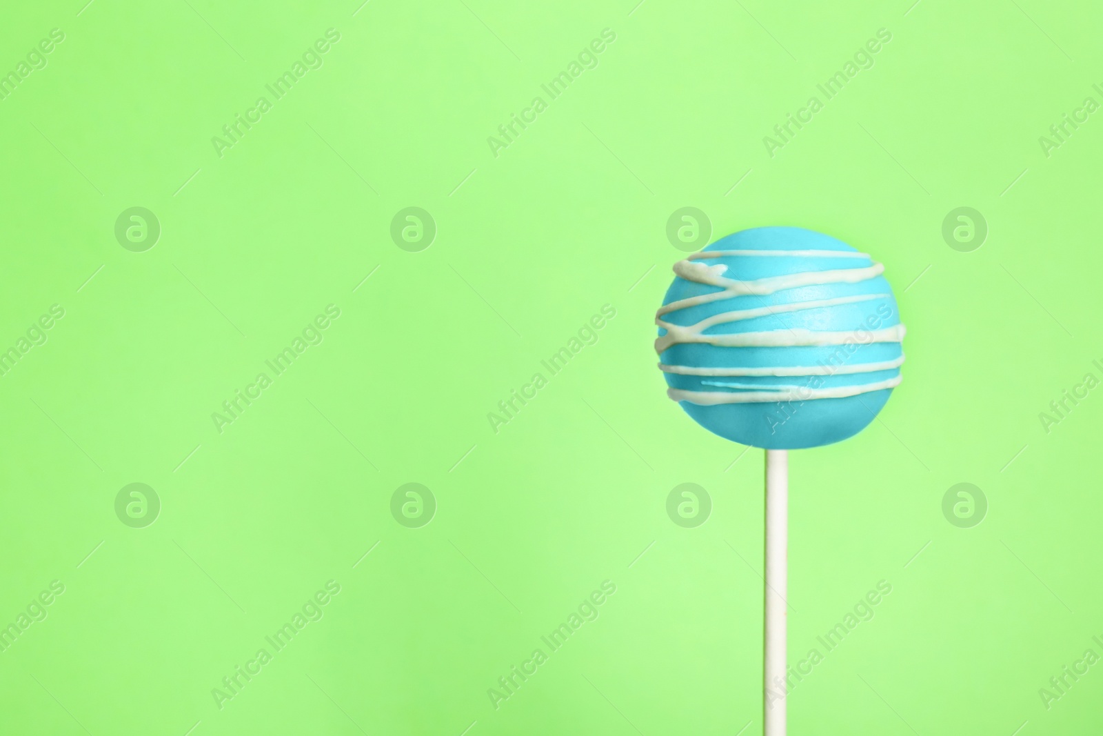 Photo of Bright delicious cake pop on color background. Space for text