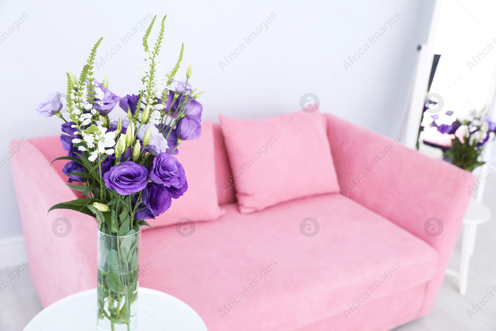 Photo of Vase with beautiful flowers on blurred background. Stylish interior