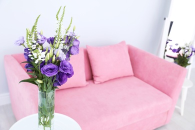 Photo of Vase with beautiful flowers on blurred background. Stylish interior