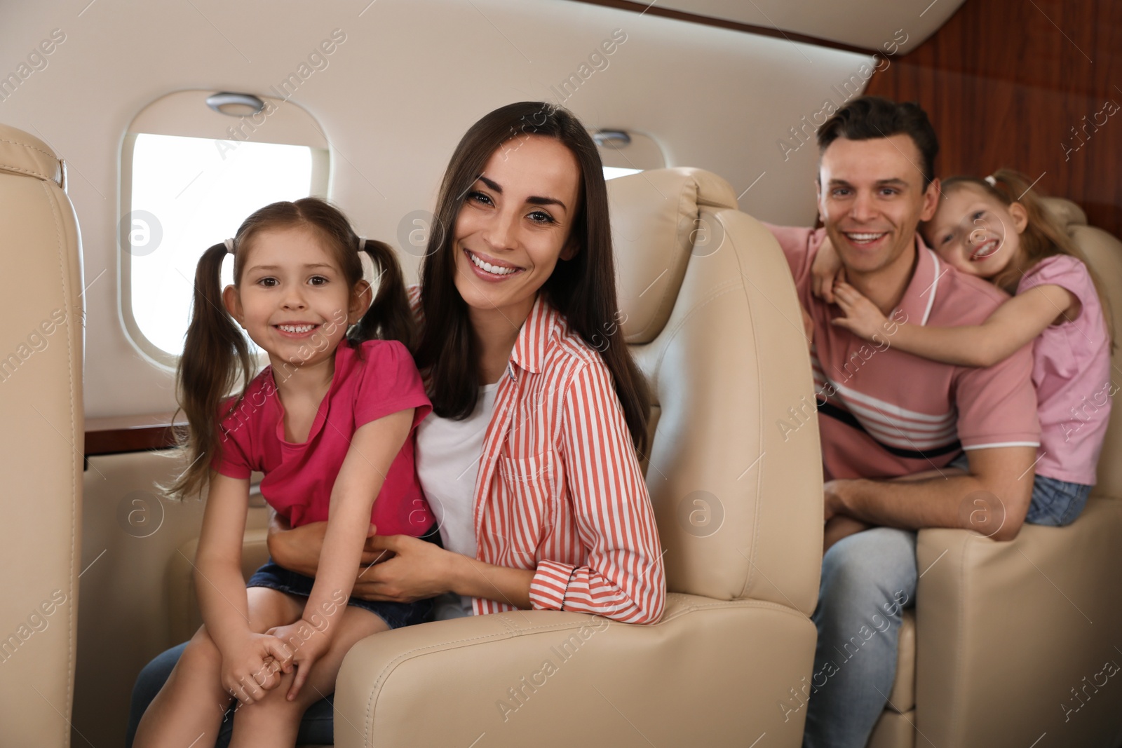 Photo of Happy family together in airplane during flight
