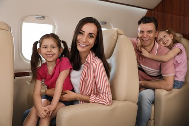 Photo of Happy family together in airplane during flight