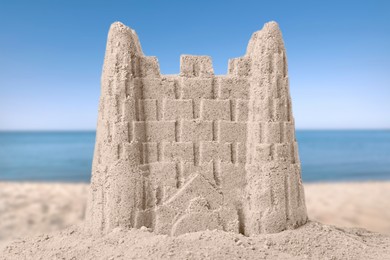 Image of Sand castle on ocean beach, closeup. Outdoor play