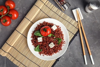 Flat lay composition with delicious cooked brown rice on table