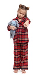 Photo of Girl in pajamas with toy bunny sleepwalking on white background