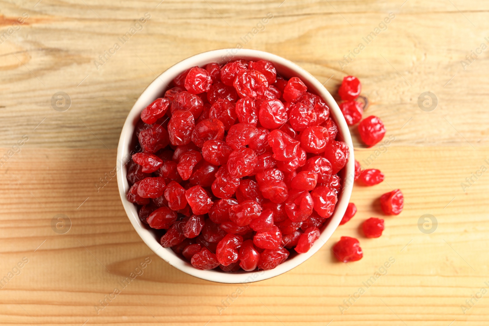 Photo of Bowl of sweet cherries on wooden background, top view. Dried fruit as healthy snack