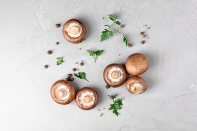 Flat lay composition with fresh champignon mushrooms on grey background