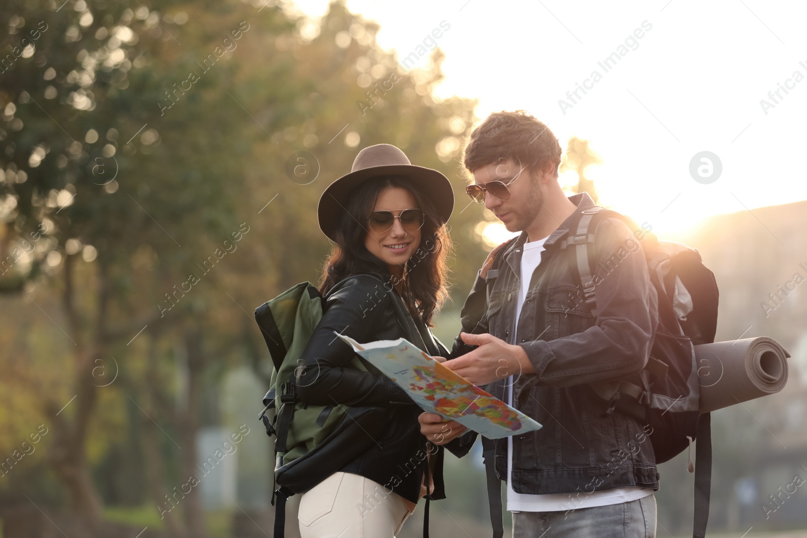 Photo of Couple of travelers with map on city street