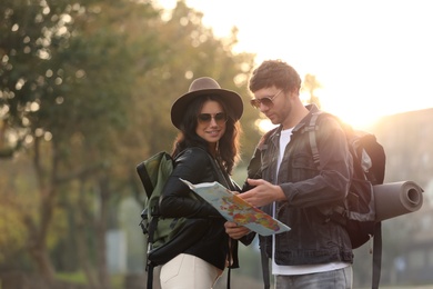 Photo of Coupletravelers with map on city street