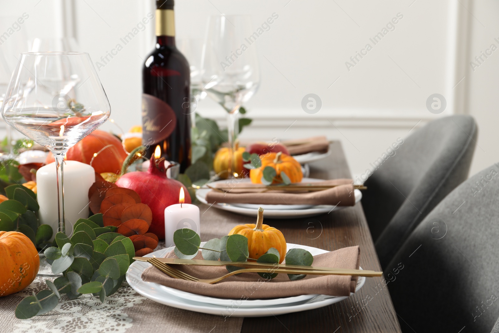 Photo of Beautiful autumn table setting. Plates, cutlery, glasses, pumpkins and floral decor