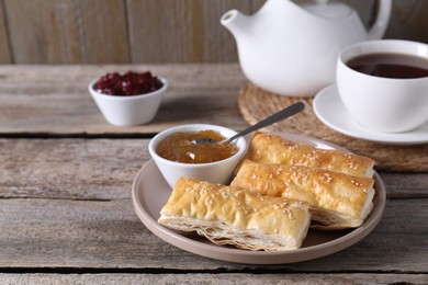 Photo of Delicious puff pastry served on wooden table