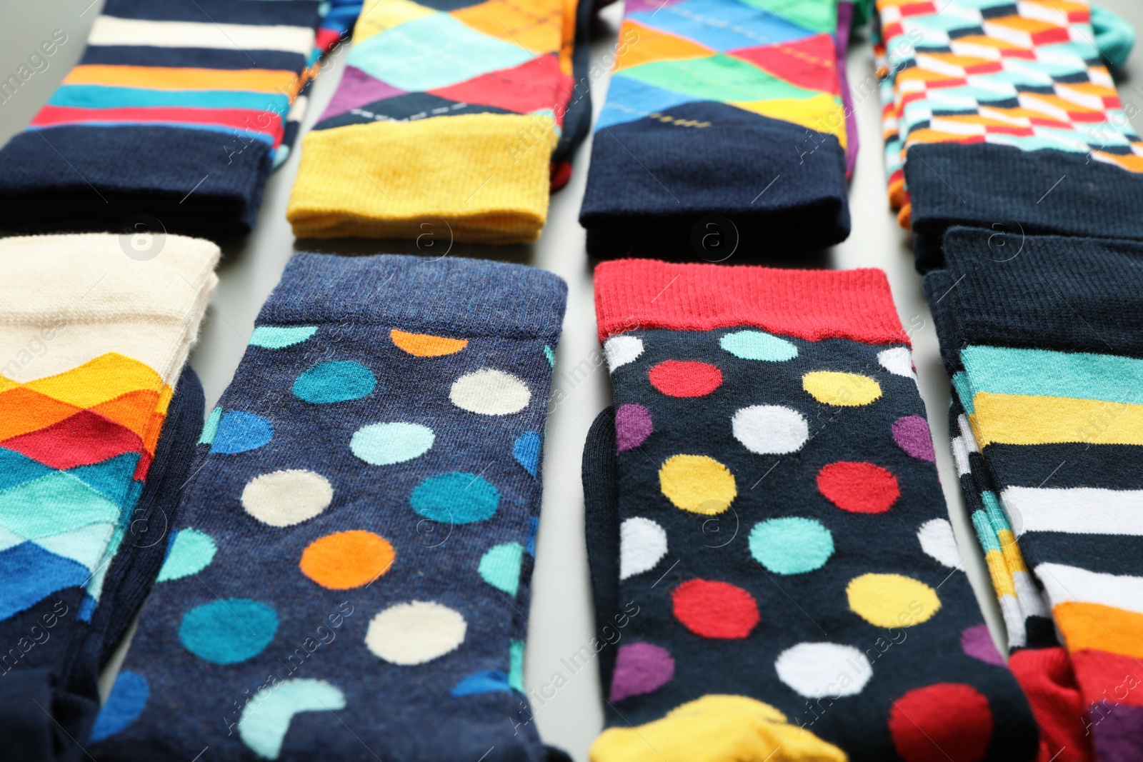 Photo of Composition with different colorful socks, closeup