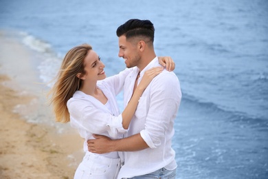 Photo of Happy couple on sea beach. Romantic walk