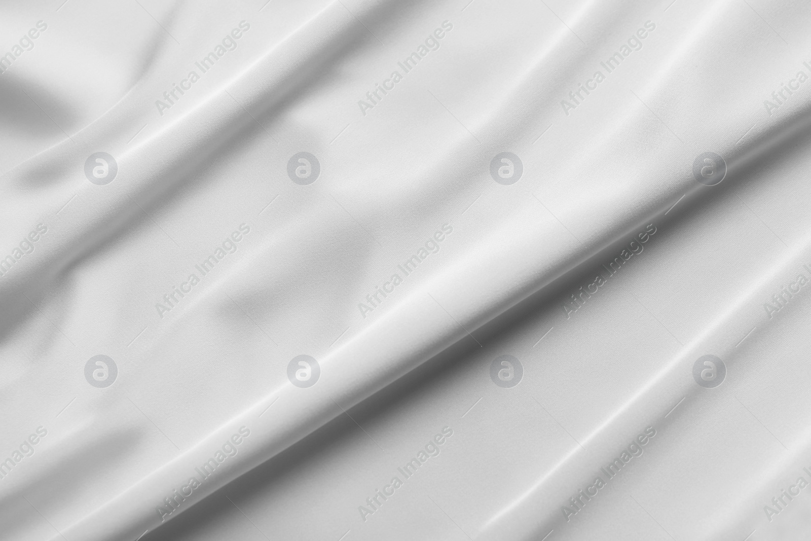 Photo of Texture of white silk ripple fabric as background, top view