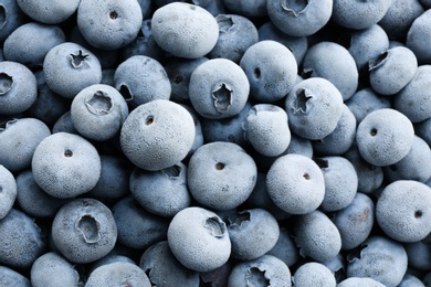 Photo of Tasty frozen blueberries as background, top view