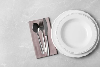 Beautiful table setting on grey marble background, flat lay