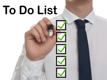 Image of To Do List. Man ticking check boxes with marker on glass board against white background, closeup