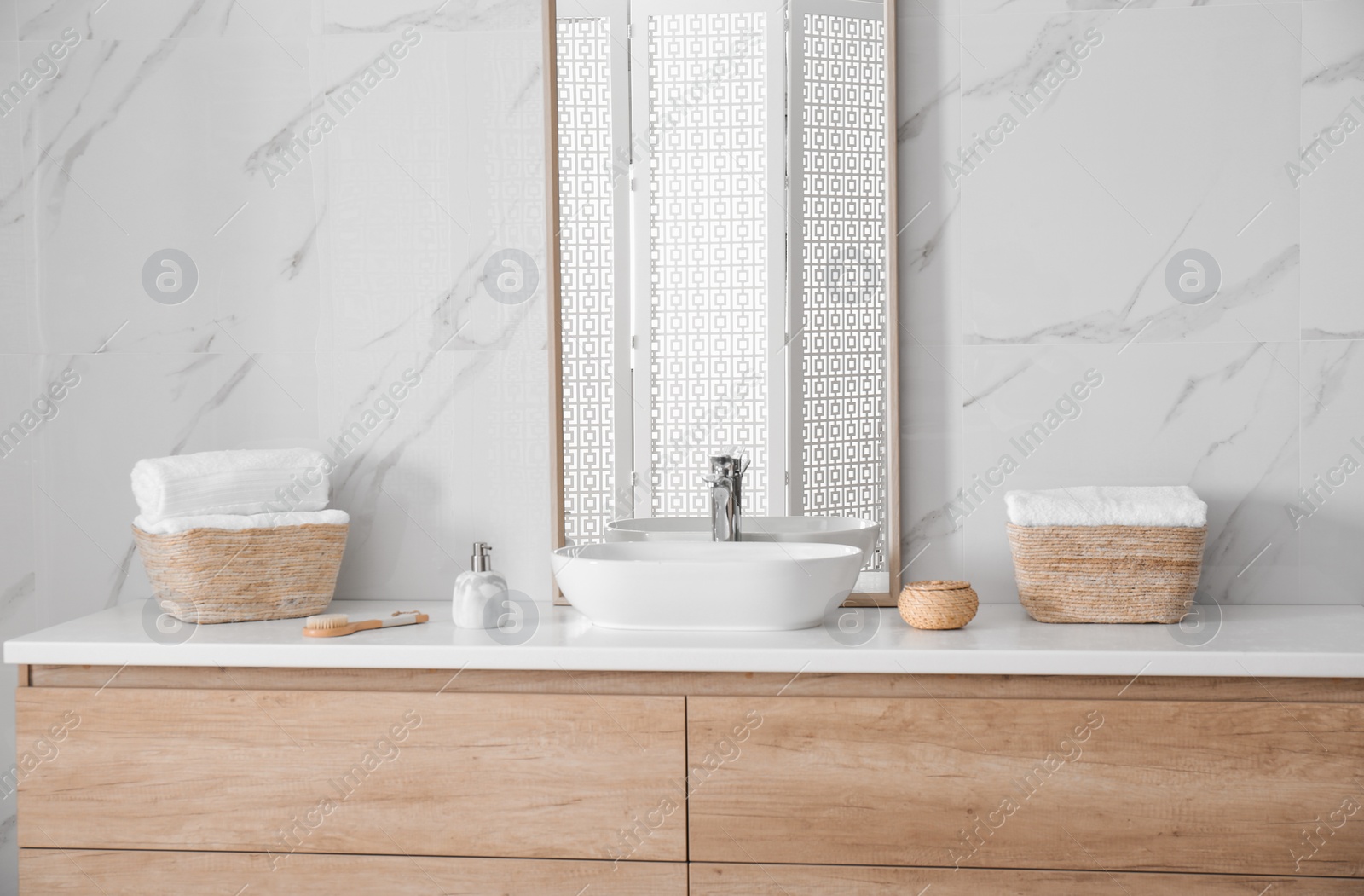 Photo of Large mirror and vessel sink in bathroom