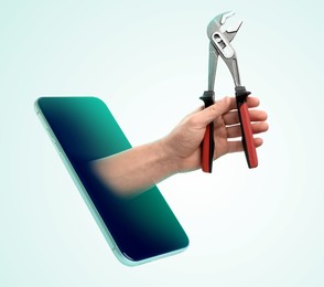 Repair service - just call. Closeup view of man with tool and smartphone on light background