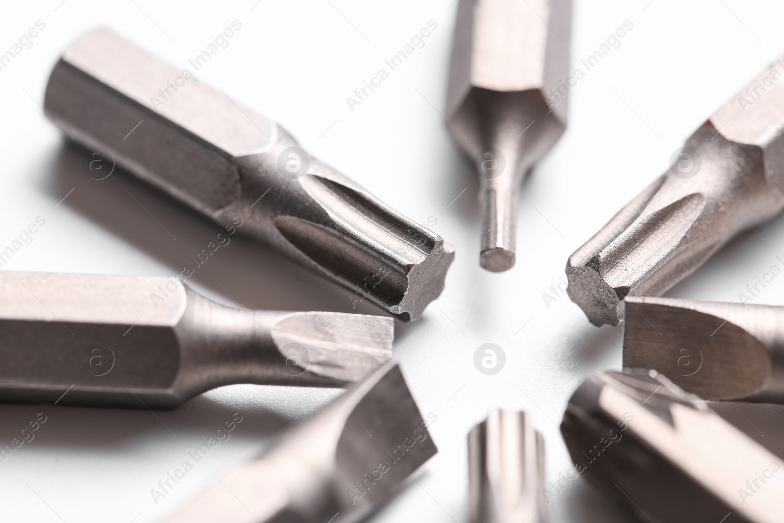 Photo of Different screwdriver bits on white background, closeup