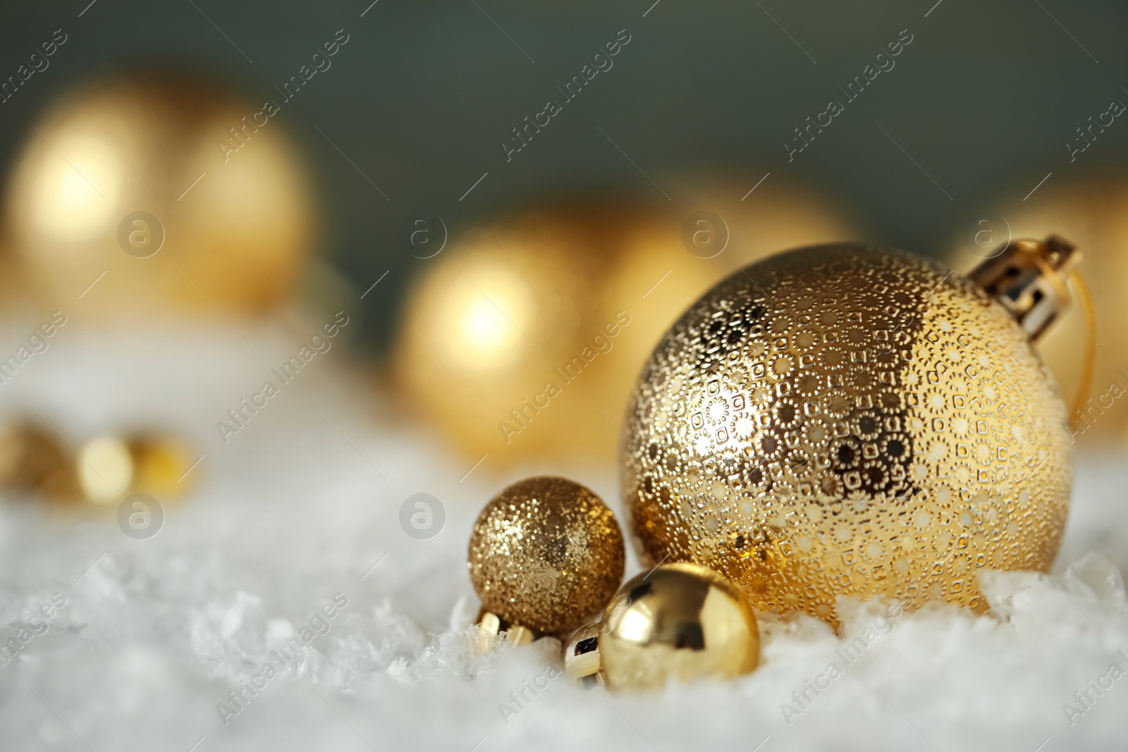 Photo of Beautiful Christmas balls on snow against blurred background. Space for text