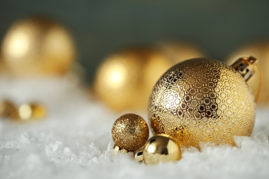 Photo of Beautiful Christmas balls on snow against blurred background. Space for text