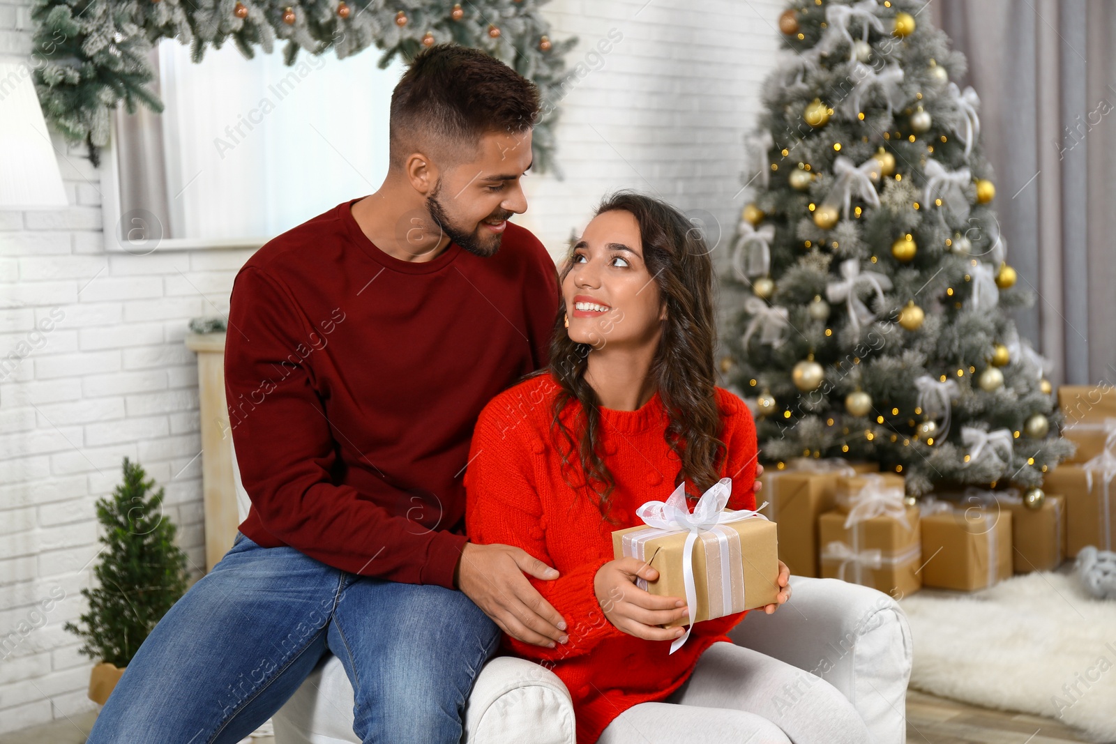 Image of Lovely couple celebrating Christmas together at home