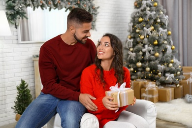 Image of Lovely couple celebrating Christmas together at home