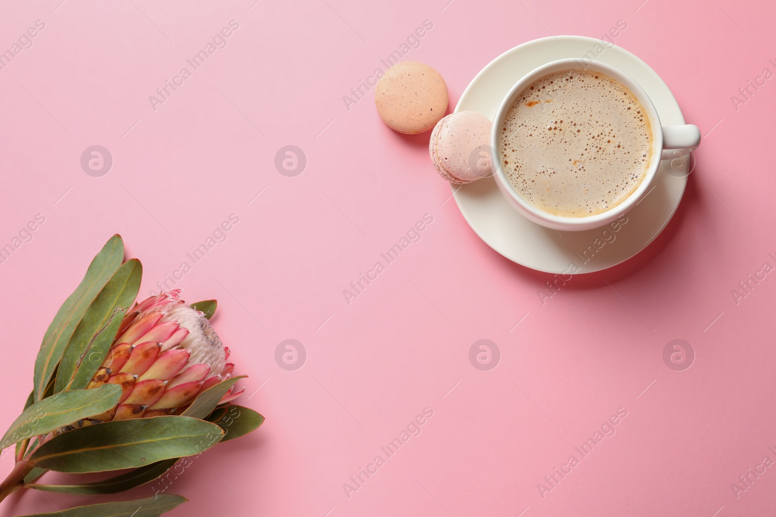 Photo of Creative flat lay composition with tropical flower, cup of coffee and macaroons on color background