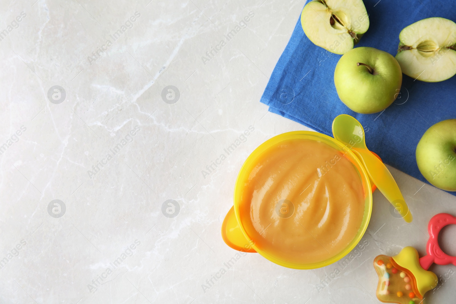 Photo of Flat lay composition with bowl of healthy baby food and space for text on light background