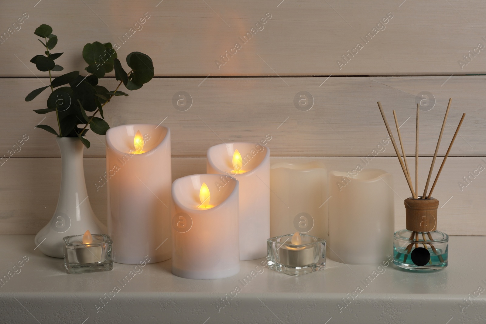 Photo of Decorative LED candles on white wooden table