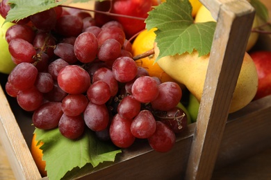 Photo of Different fresh fruits in crate, closeup view