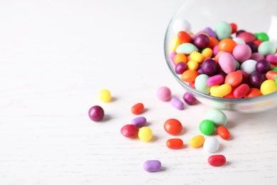Yummy candies on white table, closeup. Space for text