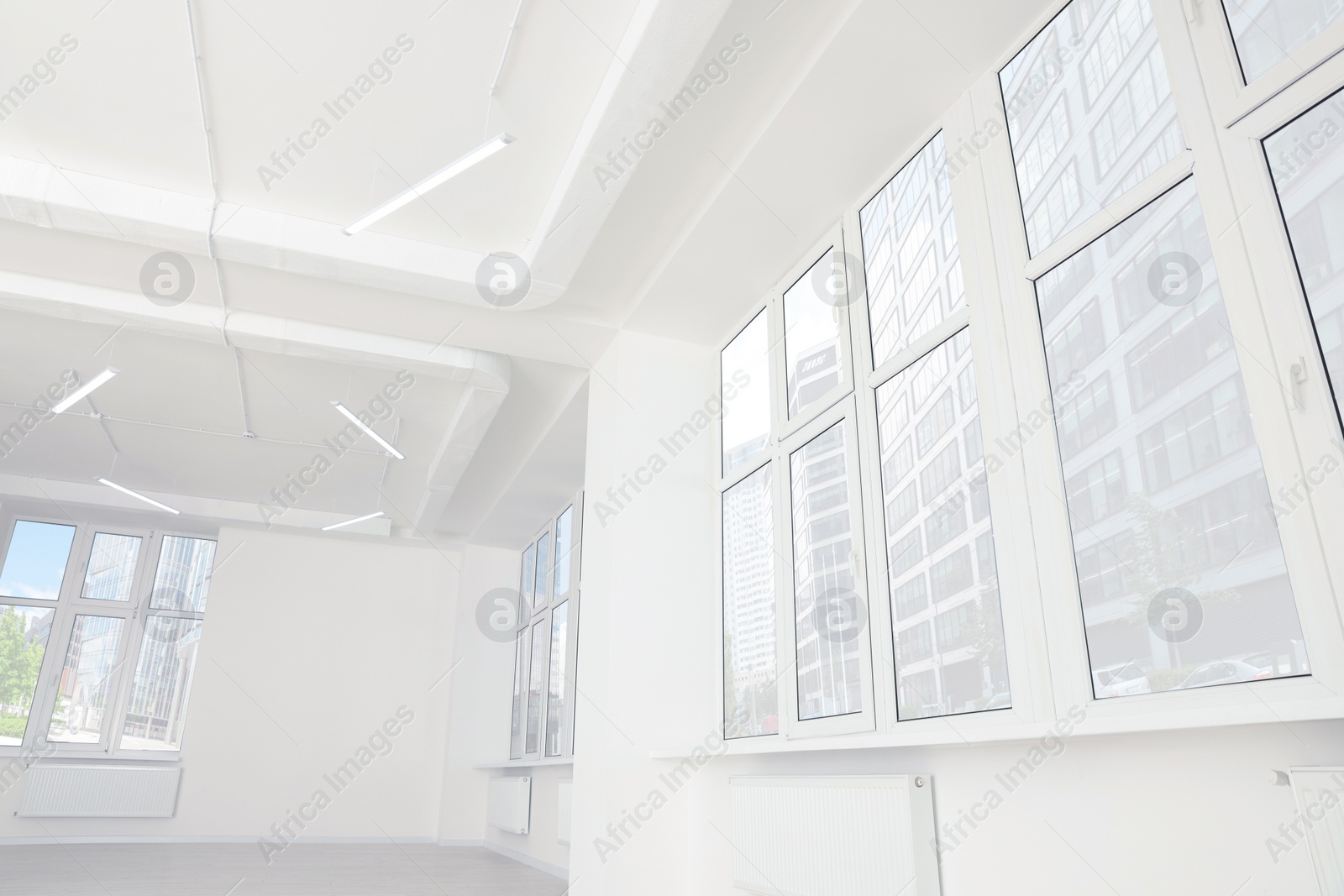 Photo of Empty office room with clean windows and lighting. Interior design