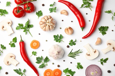 Flat lay composition with green parsley, peppercorns and vegetables on white background