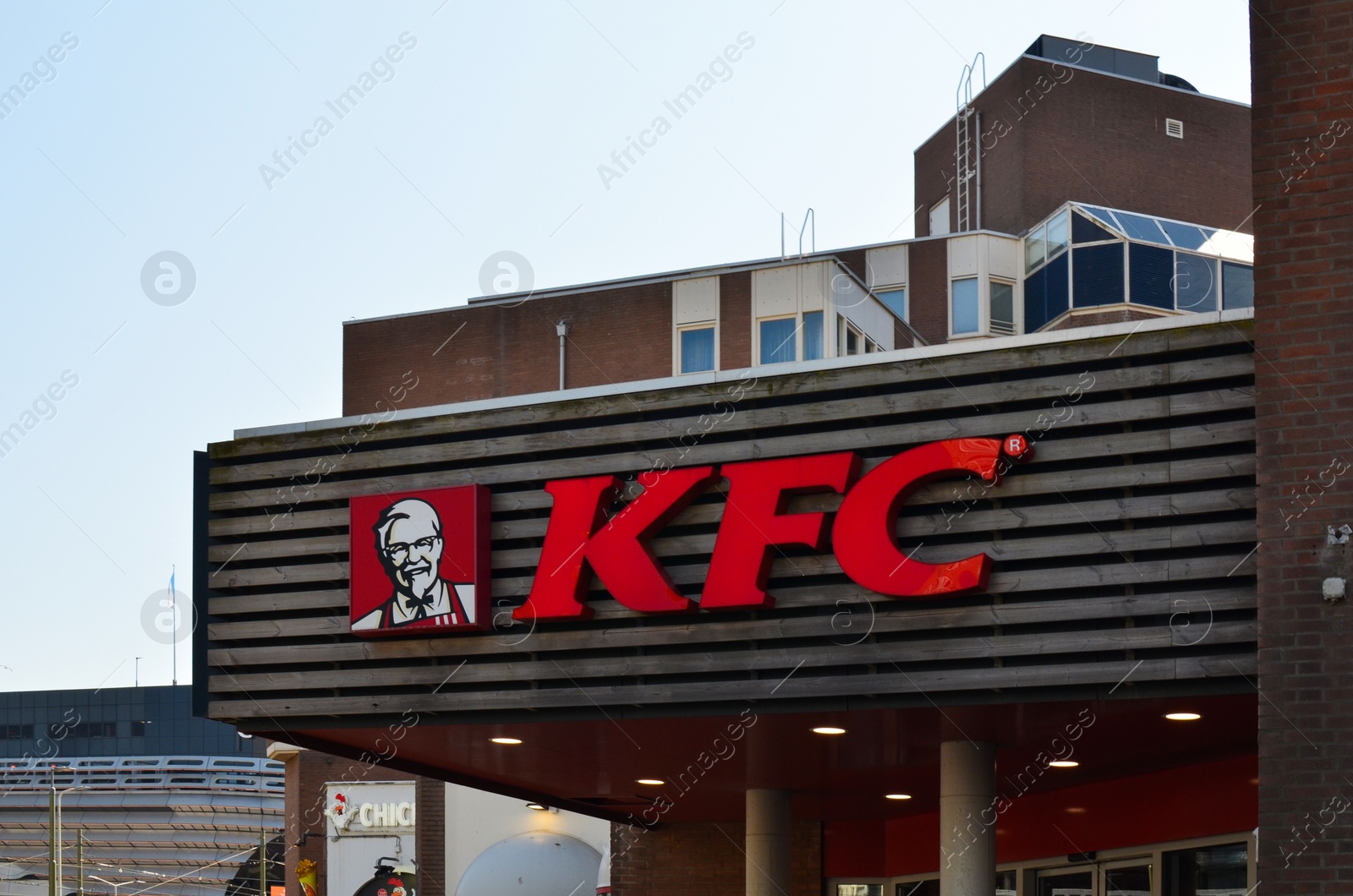 Photo of Hague, Netherlands - May 2, 2022: Exterior of KFC fastfood restaurant with logo on city street