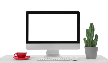 Photo of Computer, potted cactus and cup of drink on table against white background. Stylish workplace