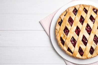 Photo of Delicious fresh cherry pie on white wooden table, flat lay. Space for text