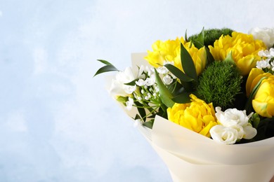 Photo of Beautiful bouquet with peony tulips on light blue background, closeup. Space for text