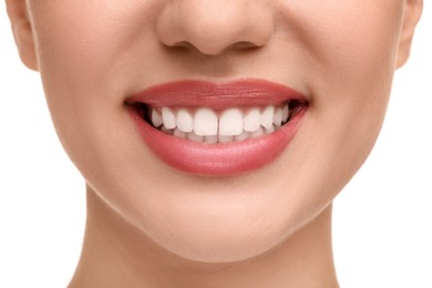 Woman with clean teeth smiling on white background, closeup