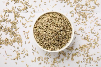 Photo of Bowl with fennel seeds on white table, top view