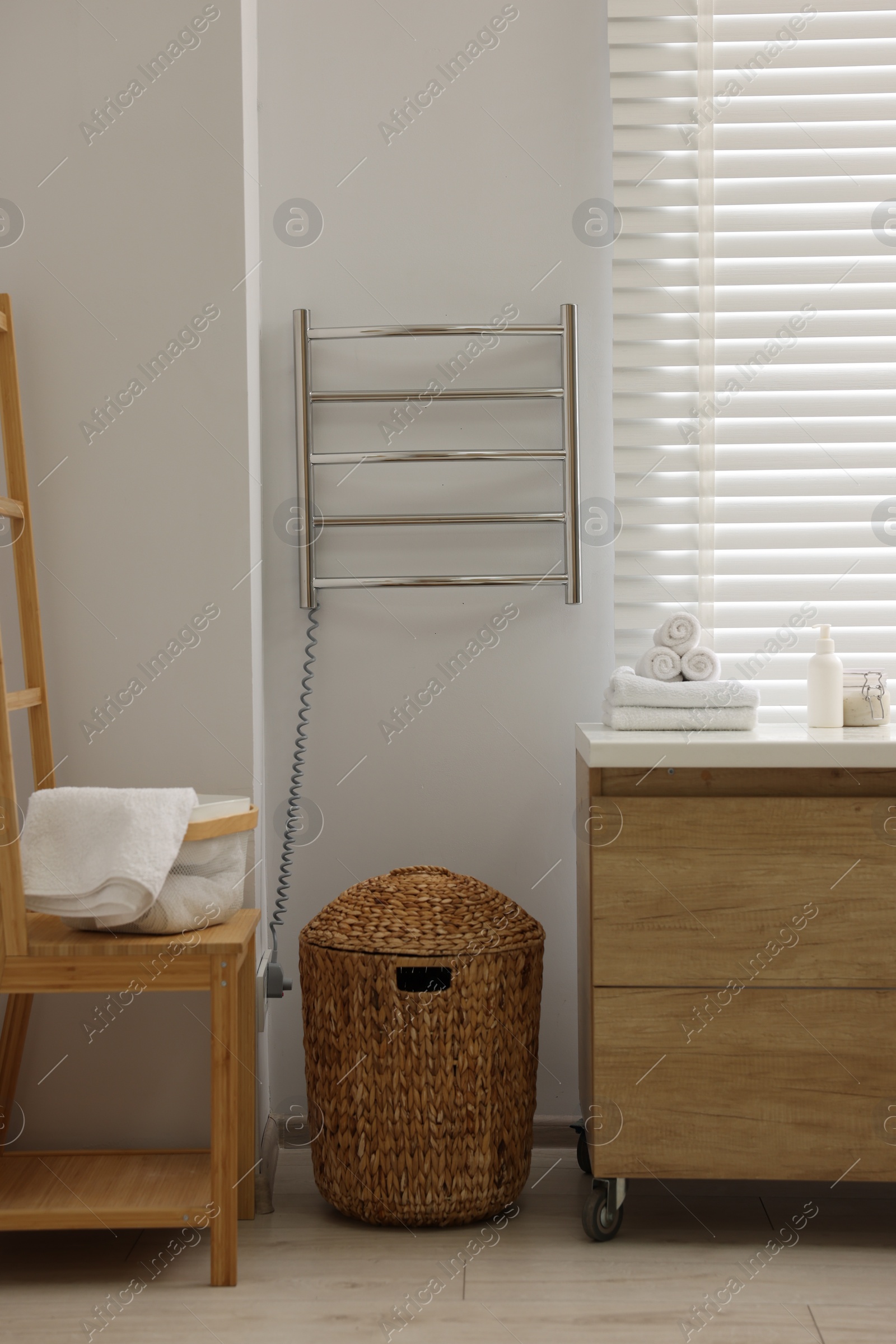 Photo of Stylish bathroom interior with heated towel rail and vanity