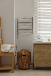 Photo of Stylish bathroom interior with heated towel rail and vanity
