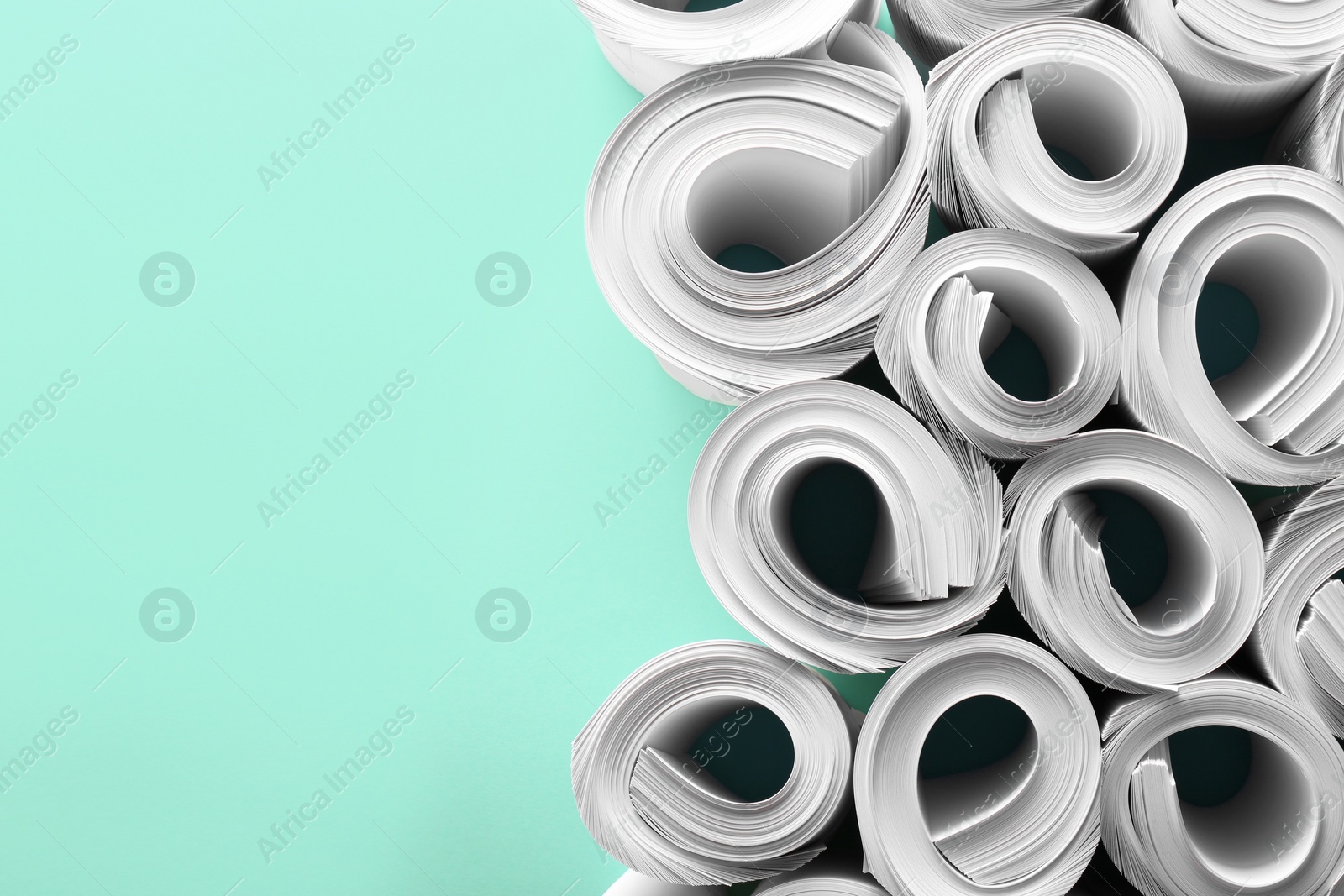 Photo of Blank white paper sheets on turquoise background, flat lay. Space for text