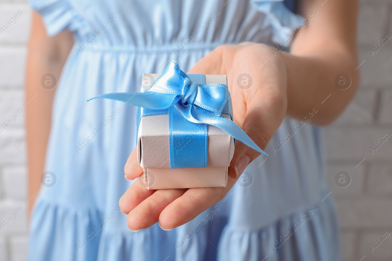 Photo of Woman holding beautiful gift box, closeup